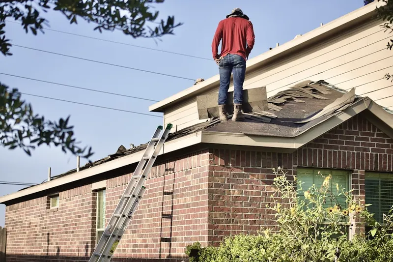 Professional roofer working on a residential roof in Republic